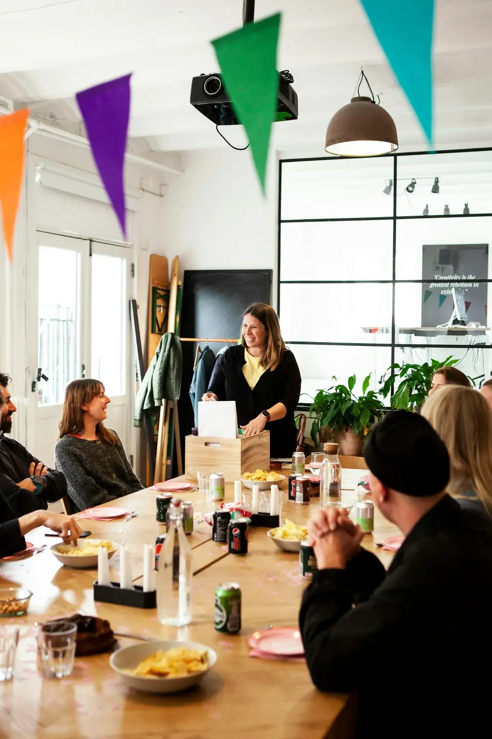 Colleagues around a long table under party bunting